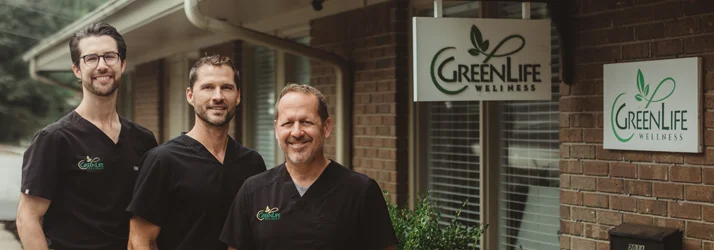 Drs. Andy Wright, Bill Barnes, and Aaron Oxenrider standing together outside the GreenLife Wellness clinic